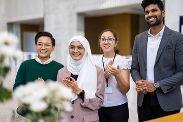 Poster - Multi-ethnic business group applauding in office
