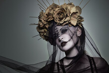 The Beautiful Girl With Marbled skin In A Wreath Of Golden Roses With Thorns And A Black Veil. Makeup Like Sewn Skin With Large Stitches.