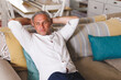 © Wavebreak Media - Thoughtful caucasian man sitting on sofa in living room