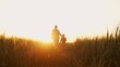 © Acronym - Farmer and his son in front of a sunset agricultural landscape. Man and a boy in a countryside field. Fatherhood, country life, farming and country lifestyle.