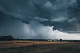 Fototapeta Krajobraz - A huge storm cloud with a wall of rain in the countryside.