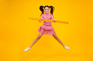 Poster - Teenager school girl study math or geometry lesson, measure the size. Mathematics ruler for measuring. Crazy jump, jumping kids. Happy positive and smiling schoolgirl.