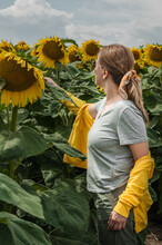 A Girl In A Field With Sunflowers.