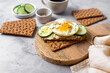 Healthy crispbread breakfast. Whole wheat with cream cheese, cucumbers and egg.  Whole Grain Crispbread for low calory diet.