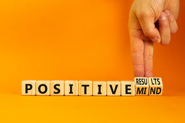 Positive results and mind symbol. Concept words Positive results or Positive mind on wooden cubes. Businessman hand. Beautiful orange background. Business positive results and mind concept. Copy space