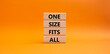 One size fits all symbol. Concept words One size fits all on wooden blocks. Beautiful orange background. Business and One size fits all concept. Copy space.