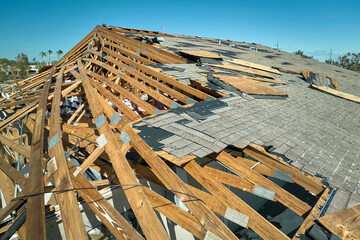 Wall Mural - Hurricane Ian destroyed house roof in Florida residential area. Natural disaster and its consequences