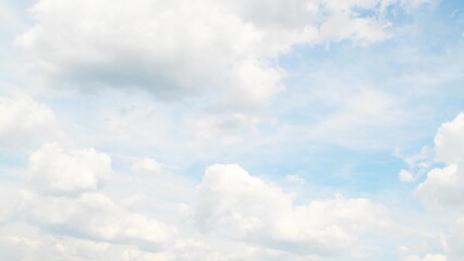 Wall Mural - Slowly moving cumulus clouds against a blue sky. Calm, peaceful landscape in summer weather. White fluffy clouds.