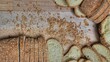 Whole grain bread close-up on the wooden cutting board. Knife with serrated blade. Fresh bread on the wooden kitchen table. Flat lay with traditional pastries in bakery.