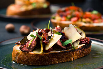 Wall Mural - Bruschetta with roast beef and sun-dried tomatoes macro close up