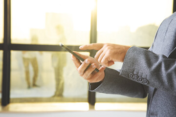 Poster - Businessman holding a phone in his hand