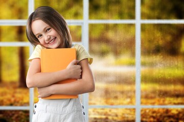 Sticker - Happy school child walking with a book