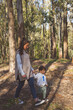 © Ignacio Carrera - a young mother walks with her little son through a park and forest enjoying the sun and nature as a family with a maternity full of love