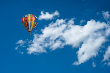 hot air balloon in the sky, big white clouds on the blue sky, nimbostratus clouds, an altostratus cl