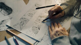 Fototapeta  - Young female artist draws sketches of comic book characters on a sheet of paper. The illustrator creates a storyboard. Storytelling concept. Video editing.