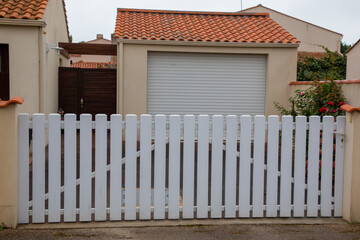 Wall Mural - PVC gates of modern house white home door slats