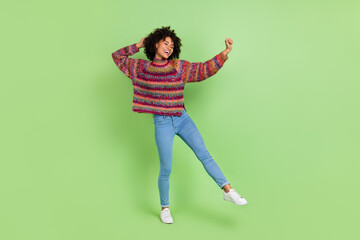 Wall Mural - Photo of shiny charming lady dressed knitted pullover dancing smiling isolated green color background