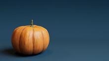 Pumpkin On A Blue Grey Colored Background. Autumn Themed Image With Copy-space.