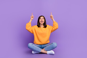 Canvas Print - Full body size photo of charming adorable lady sitting crossed legs looking up fingers point mockup useful tips isolated on bright violet color background