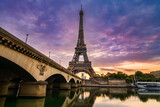Fototapeta Miasta - Eiffel Tower by seine river at sunrise in Paris. France