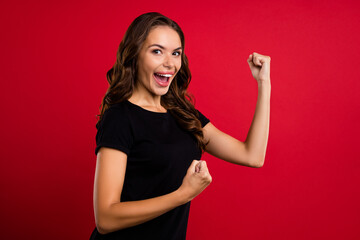 Poster - Profile side photo of young excited girl celebrate success discount awesome fists hands isolated over red color background