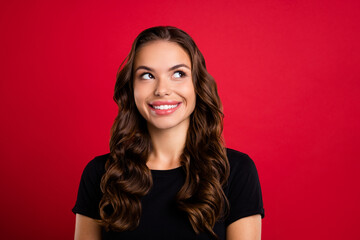 Canvas Print - Photo of youth cheerful lovely girl curious look empty space idea think isolated over red color background