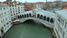 4K Aerial of San Marco, the Rialto Bridge, and the canals in Venice, Italy on a cloudy day.