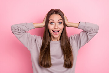 Poster - Portrait of astonished nice lady arms touch head toothy smile isolated on pink color background