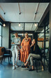 © Jacob Lund - Three diverse businesswomen smiling at the camera in an office