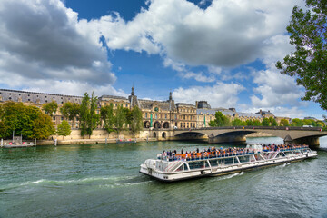 Wall Mural - Beautiful scenery of Paris with ferry boat near Pont du Carrousel bridge. France