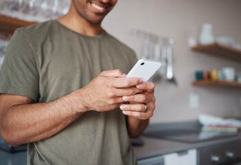 Aufkleber - Hands, phone and man texting in a kitchen, relax and smile while reading social media message. Internet, communication and guy planning fun vacation day, streaming and enjoying online app in his home