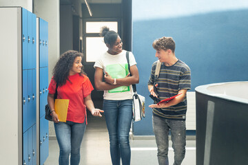 Multi ethnic group of confident and happy high school student friends going back to classes arriving to College