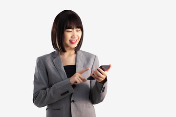 Poster - Asian business woman short hair wear grey suit using and touching screen smartphone on white background.
