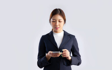 Poster - Young asian business woman using smartphone on white background.