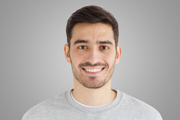 Wall Mural - Close-up daylight portrait of handsome man with smile isolated on gray background