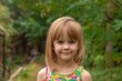 © Mikhail - Portrait of a beautiful little girl with  blond hair on a background of summer greenery.