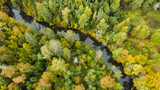 Fototapeta Pomosty - forest and river at sunset in autumn. Aerial view of wildlife in Latvia, Europe