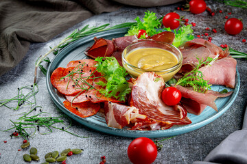 Wall Mural - Meat platter, assortment. Appetizers on the gray stone table