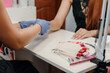 © Denys Kurbatov - Female manicurist applying moisturizing cream on client's hand after procedure
