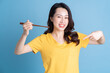 © Timeimage - Image of young Asian woman holding chopstick