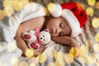 © Marina Demidiuk - Cute Sleeping Young Boy in Santa Claus Hat Lying in Bed at Home. Christmas Light. Winter Holiday Concept. Dream. Toddler Baby Celebrating Christmas. Merry Xmas, Happy New Year. Funny Little Child.