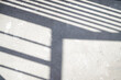 © Mykola - The sun is casting railing shadow over the white concrete wall and floor.