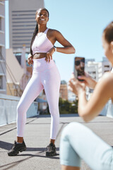 Canvas Print - Fitness influencer friends with smartphone photo for social media update on wellness lifestyle and body progress results. Gen z marketing girl taking photo of black woman for sports fashion website