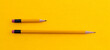 © xy - Long and short pencils on yellow background