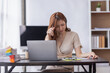 © David - Asian businesswoman are stressed while working on laptop, Tired asian businesswoman with headache at office, feeling sick at work copy space in workplace an home office.