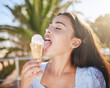 Ice cream cone eating, woman and summer dessert to enjoy on vacation, holiday and relaxing weekend in Portugal. Happy young girl licking melting gelato icecream outdoors for cool, fun and sweet snack
