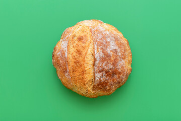 loaf of bread on a green table, above view