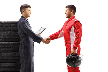 Wall Mural - Car mechanic shaking hands with a professional racer