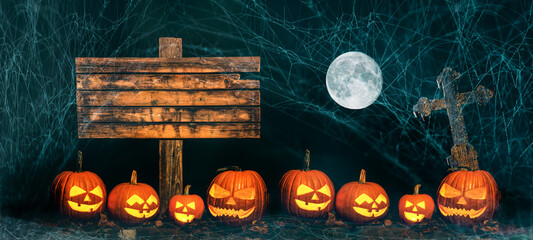 Wall Mural - Mystery Halloween holiday party card background banner panorama - Old blank weathered wooden sign, carved glowing pumpkins, spider webs, cross and full moon in the dark night