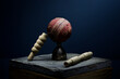 Cricket ball and bails still life in moody light with a blue background
